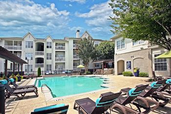 pool with sundeck and patio seating